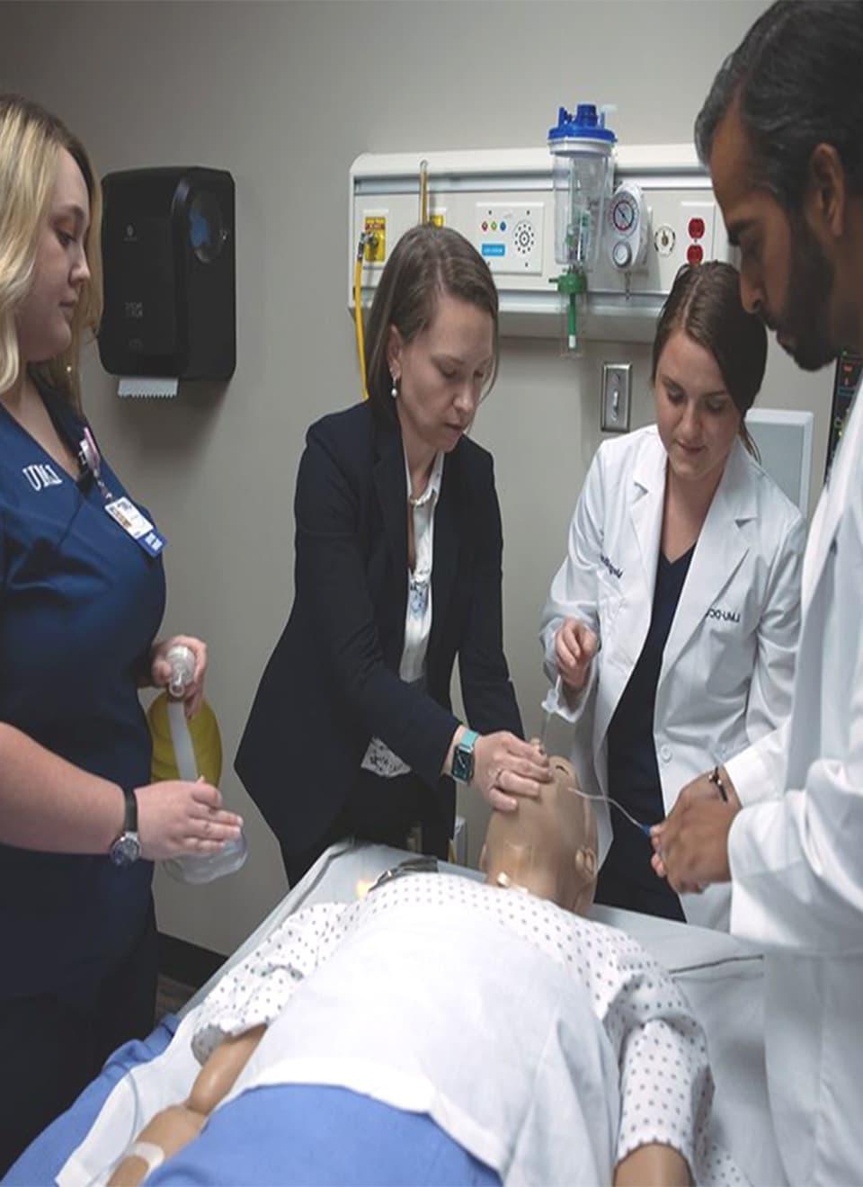 students in hospital room with test patient